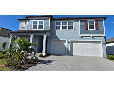 Two story home with attached garage and manicured landscaping at 6916 E 115Th St, Palmetto, FL 34221