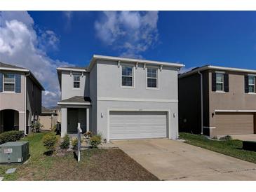 Charming two-story home featuring a two-car garage and neutral stucco exterior at 2855 Maiden Grass Isle, Wesley Chapel, FL 33543