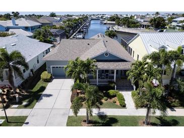 Aerial view showcasing a house with gray-blue exterior, driveway, and landscaping at 406 Islebay Dr, Apollo Beach, FL 33572