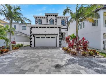 Stunning two-story home with lush landscaping, a paved driveway, and a two-car garage at 534 Estuary Shore Ln, Apollo Beach, FL 33572