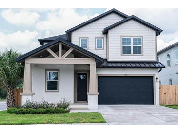 Two-story craftsman style home with gray siding at 213 W Giddens Ave, Tampa, FL 33603
