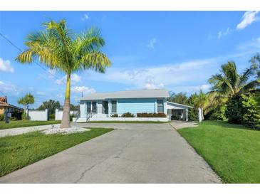 Light blue house with palm trees and a long driveway at 821 White Heron Blvd, Ruskin, FL 33570