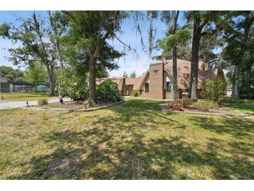 Dome-shaped home with brick exterior and landscaping at 2512 Ayers Hill Ct, Lutz, FL 33559