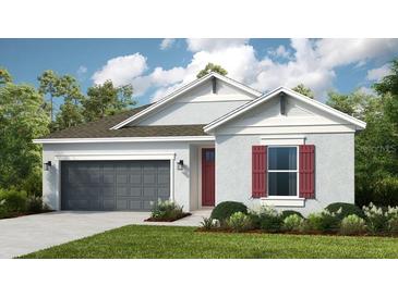 Attractive one-story home with gray siding, red shutters, and a two-car garage at 10571 Piedra Dr, Palmetto, FL 34221