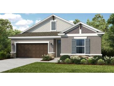Attractive one-story home with brown garage door and stone accents at 10575 Piedra Dr, Palmetto, FL 34221