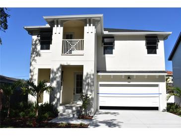 Charming two-story home featuring a clean white exterior and an attached two-car garage at 7205 S De Soto St, Tampa, FL 33616