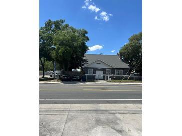 Gray house with mature trees and street view at 3008 N Nebraska Ave, Tampa, FL 33603