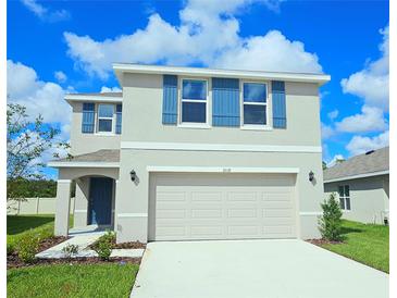 Two story home with blue shutters and a two car garage at 3018 Rock Sound St, Bradenton, FL 34208