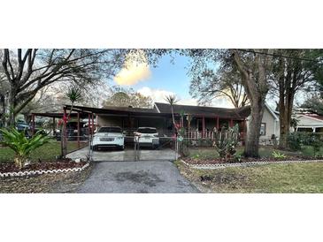 House exterior with carport and fenced yard at 6902 Rhode Island Dr, Tampa, FL 33619