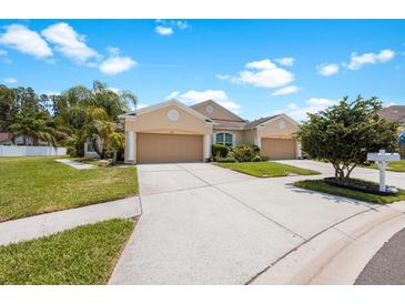 Tan duplex with two-car garages at 30315 Lettingwell Cir, Wesley Chapel, FL 33543