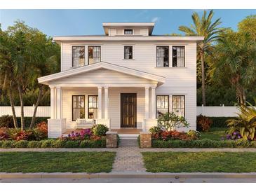 Inviting two-story home featuring a covered porch, complemented by lush landscaping and a well-manicured lawn at 2823 4Th N Ave, St Petersburg, FL 33713