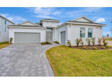 Two-story house with gray garage doors and a paved driveway at 8328 Golden Beach Ct, Parrish, FL 34219