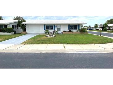 Ranch-style home with a well-manicured lawn at 10032 36Th N St, Pinellas Park, FL 33782