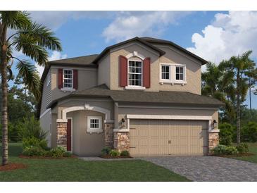 Two-story house featuring a two-car garage, stone accents, and red shutters at 2868 Misty Marble Dr, Zephyrhills, FL 33540