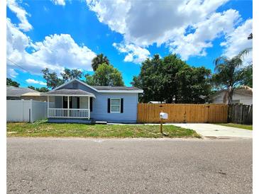 Cute bungalow with a fenced yard and a covered porch at 1703 Mobile Ave, Tampa, FL 33610
