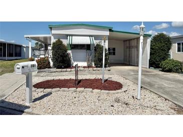 Charming single-story home featuring a well-maintained landscape, carport, and inviting curb appeal at 107 E Saint Johns Way, Apollo Beach, FL 33572