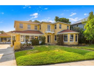 Two story yellow brick home with a large yard at 803 Bayshore Blvd, Tampa, FL 33606