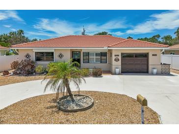 Single-story home with circular driveway and landscaping at 186 45Th Ave, St Pete Beach, FL 33706