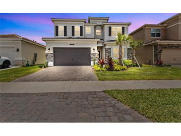 Two-story home with two-car garage and landscaping at 32588 Tree Of Life Ave, Wesley Chapel, FL 33543