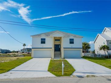 Two story house with a double garage and a large yard at 3431 Sheephead Dr, Hernando Beach, FL 34607