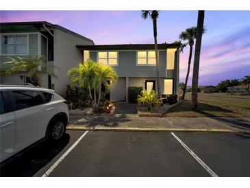 Evening view of condo building exterior, showcasing landscaping and parking at 1028 Apollo Beach Blvd # 27, Apollo Beach, FL 33572