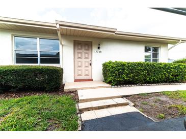 Updated condo exterior with manicured hedges and a welcoming entrance at 2220 Grenadier Dr # 2220, Sun City Center, FL 33573