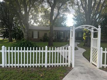 House exterior with white picket fence and landscaped yard at 10520 Henderson Rd, Tampa, FL 33625