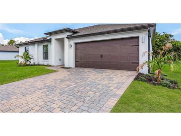 Modern house exterior with a paved driveway at 5473 Colfax Ter, Port Charlotte, FL 33981