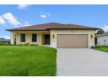 Exterior of a single-story home with a two-car garage and manicured lawn at 9187 Prospect Ave, Englewood, FL 34224
