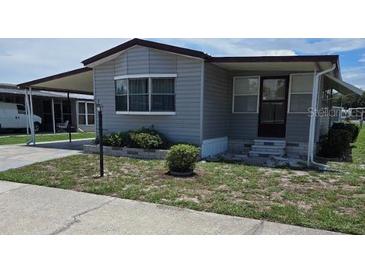 Mobile home with carport and landscaped yard at 1710 7Th Sw St # 103, Ruskin, FL 33570