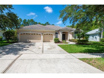 Spacious home with three-car garage and landscaped yard at 6120 Cezanne Ave, Lutz, FL 33558