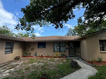Exterior view of a ranch house with a well-maintained lawn at 6297 Harcross Ct, Spring Hill, FL 34606