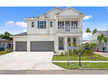 Beautiful two-story home with a manicured lawn, a two-car garage, and inviting front porch at 4017 W Fig St, Tampa, FL 33609