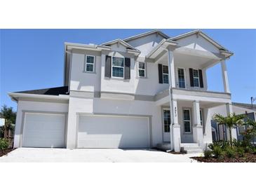Elegant two-story home with white stucco, decorative shutters, and a covered front entry at 4017 W Fig St, Tampa, FL 33609