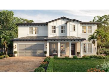 Two-story farmhouse with gray garage and landscaping at 3416 W Barcelona St, Tampa, FL 33629