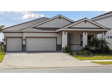Charming single-story home featuring a spacious three-car garage and well-manicured landscaping at 10324 Longmeadow Ave, Parrish, FL 34219