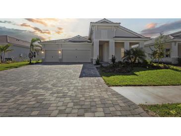 Two-story home with attached garage and landscaped yard at 10422 Longmeadow Ave, Parrish, FL 34219