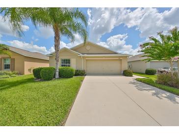 Single-Gathering home with attached garage and manicured lawn at 16903 Peaceful Valley Dr, Wimauma, FL 33598