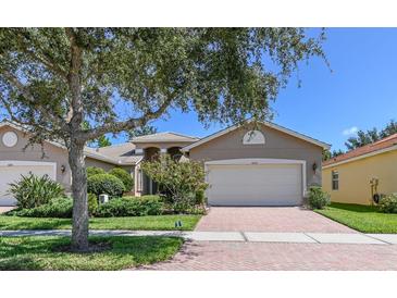 Attractive one-story home with a two-car garage and manicured lawn at 16252 Amethyst Key Dr, Wimauma, FL 33598