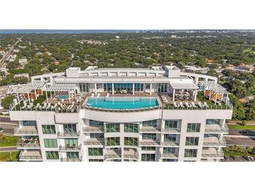 Aerial view of a luxury highrise building with rooftop pool and city views at 2910 W Barcelona St # 903, Tampa, FL 33629