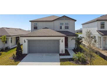 Charming two-story home featuring a two-car garage and well-maintained landscaping at 10607 Hidden Banks Gln, Parrish, FL 34219