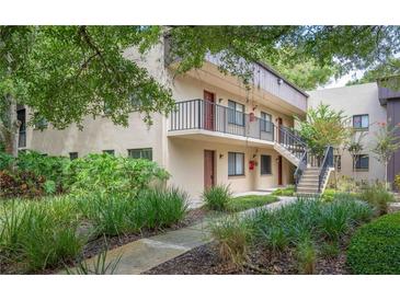 Two story building exterior with lush landscaping at 11702 Raintree Village Blvd # A, Temple Terrace, FL 33617