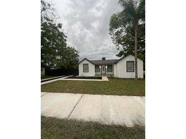 Charming house with white exterior, landscaping, and walkway at 5238 16Th St, Zephyrhills, FL 33542