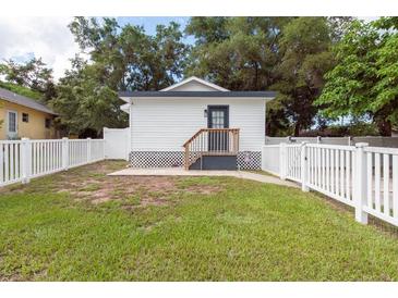 Small cottage with white exterior and fenced yard at 4622 Paloverde Dr, New Port Richey, FL 34652