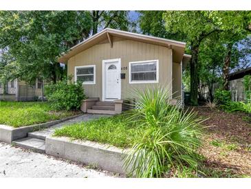 Tan house with white door and steps at 405 E Dr Martin Luther King Jr Blvd, Tampa, FL 33603