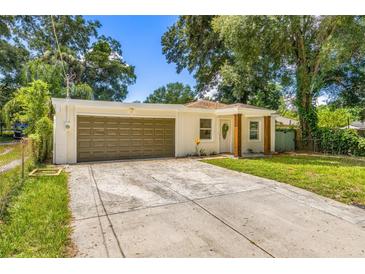 Updated bungalow with attached garage and a well-maintained lawn at 701 E Crenshaw St, Tampa, FL 33604