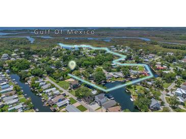 Stunning aerial view of waterfront homes and lush surroundings, near Gulf of Mexico, highlighting the community's unique location at 5369 Tuscawilla Dr, Weeki Wachee, FL 34607