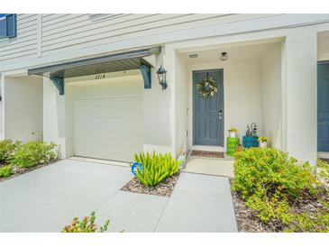 Townhouse with a modern gray door and well-maintained landscaping at 2714 Chestnut Creek Pl, Brandon, FL 33510