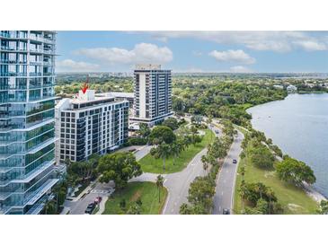 Aerial view of a condo building near the water, showing surrounding buildings and roads at 707 S Gulfstream Ave # 602, Sarasota, FL 34236