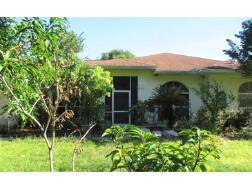 House exterior with lush landscaping and brown roof at 33255 State Road 70 E, Myakka City, FL 34251